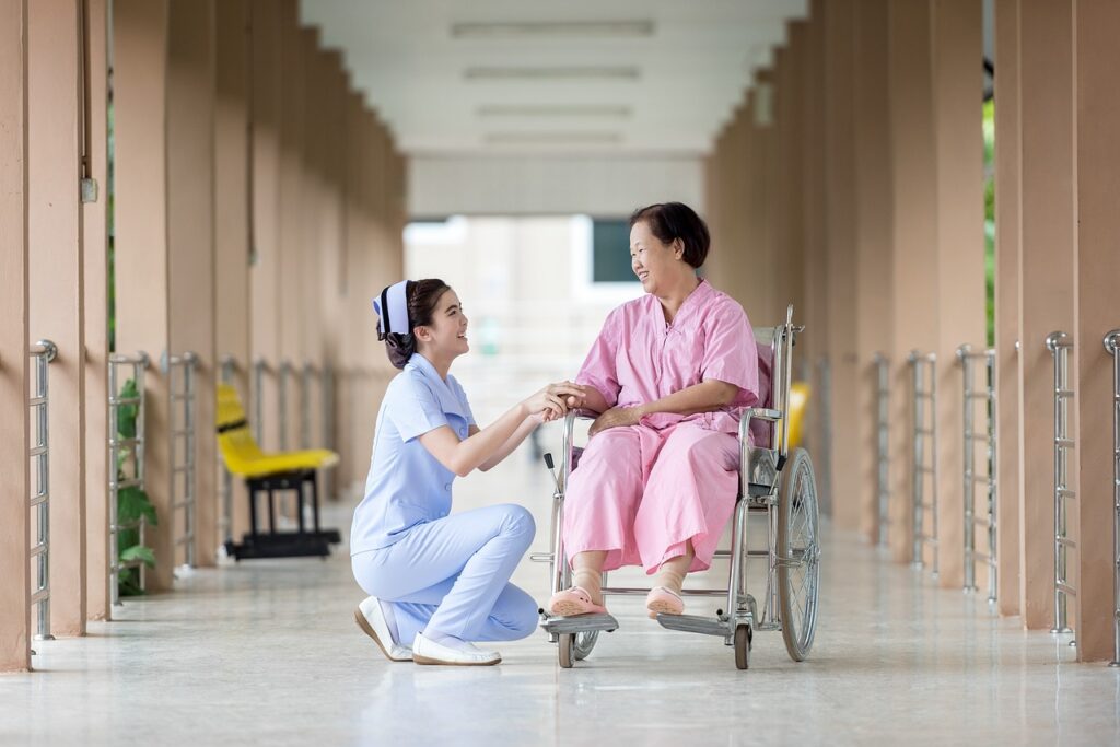 a nurse taking care of a disabled person in a wheel chair 