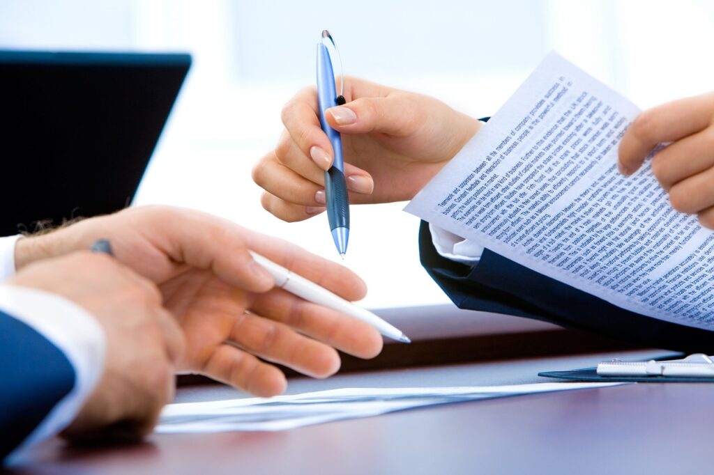 a man holding a pen doing paperwork