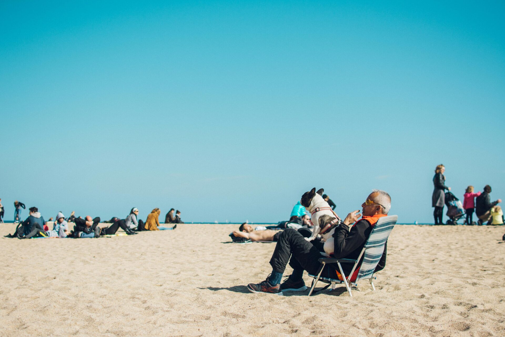 a man sitting on a chair with a dog